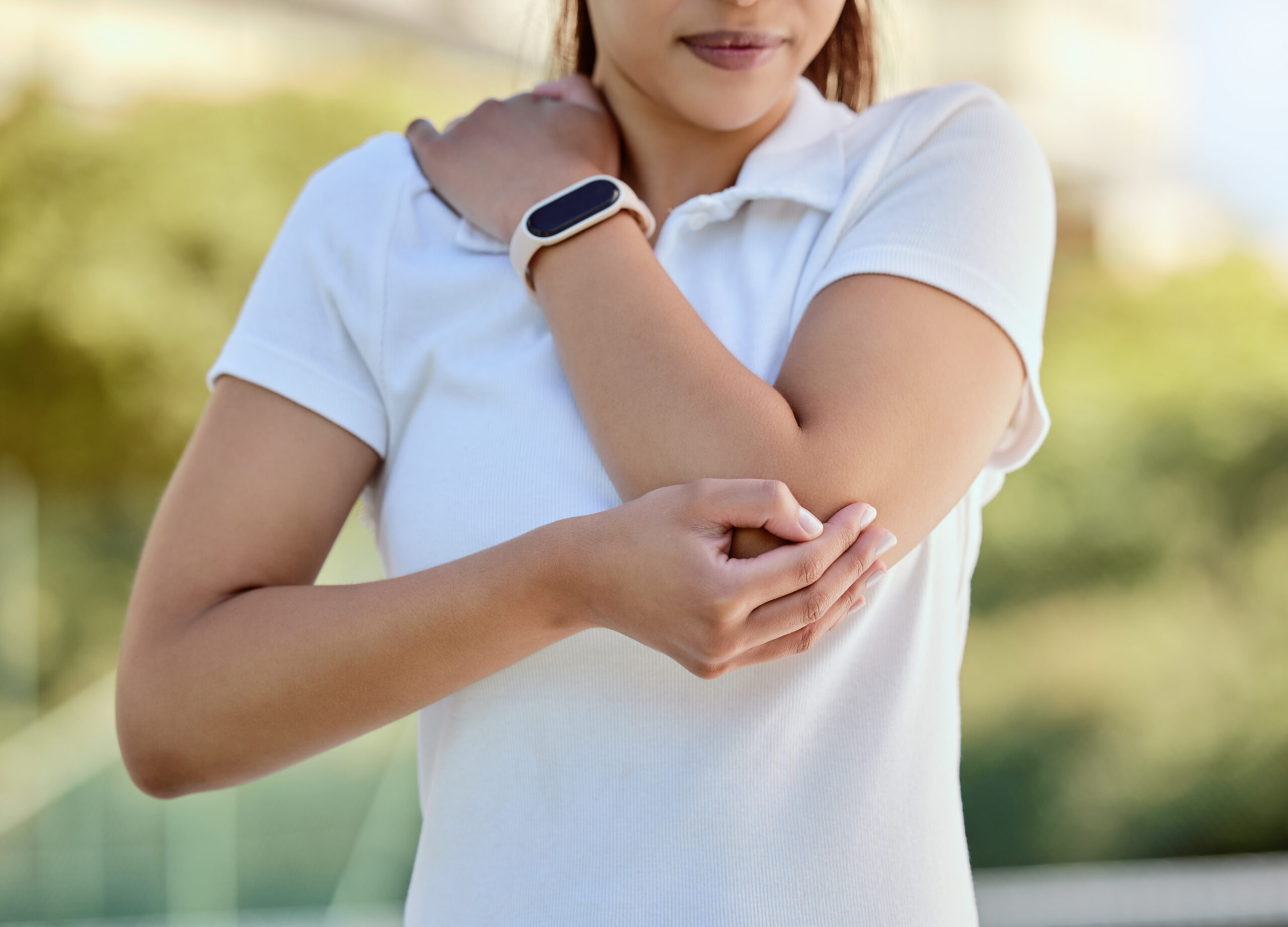 Tennis elbow, sports and a woman with injury, fitness and training game on court. Workout, sport ex