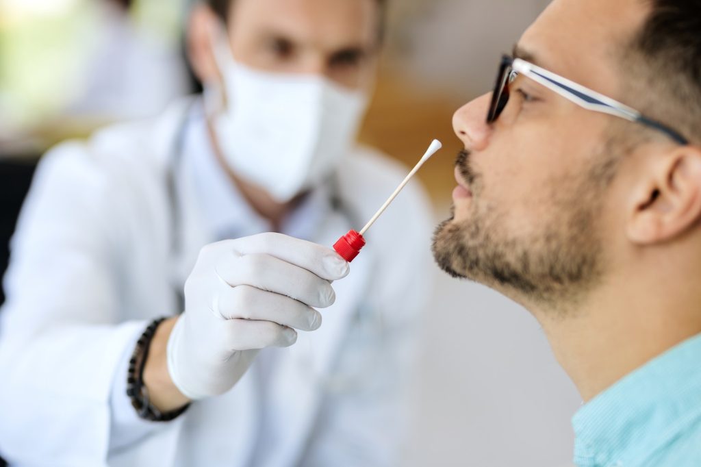Close-up of a man having PCR test at medical clinic.
