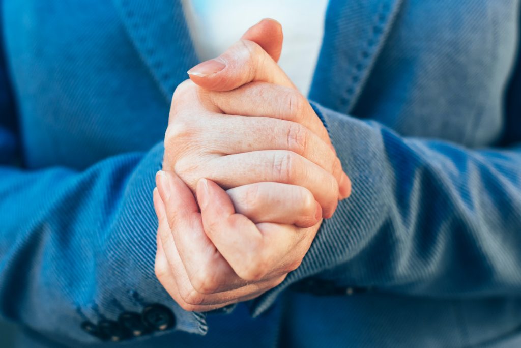 Nervous businesswoman hands, close up