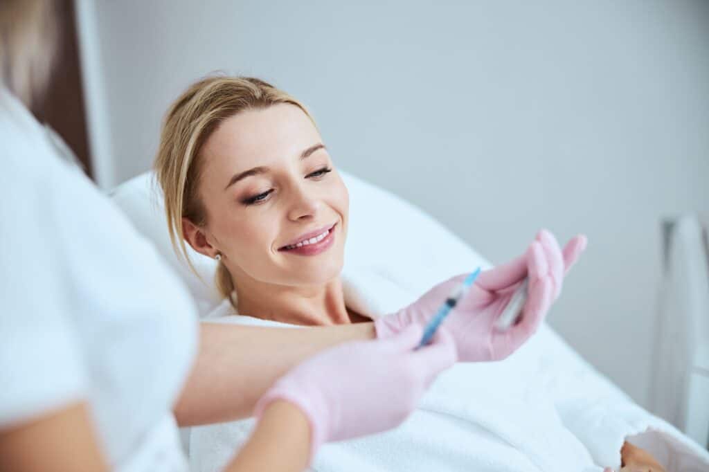 Dermatologist demonstrating the medical tools to a female patient
