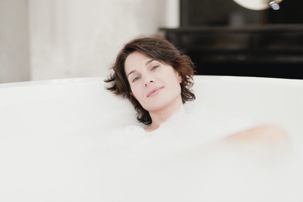 Smiling woman taking bubble bath