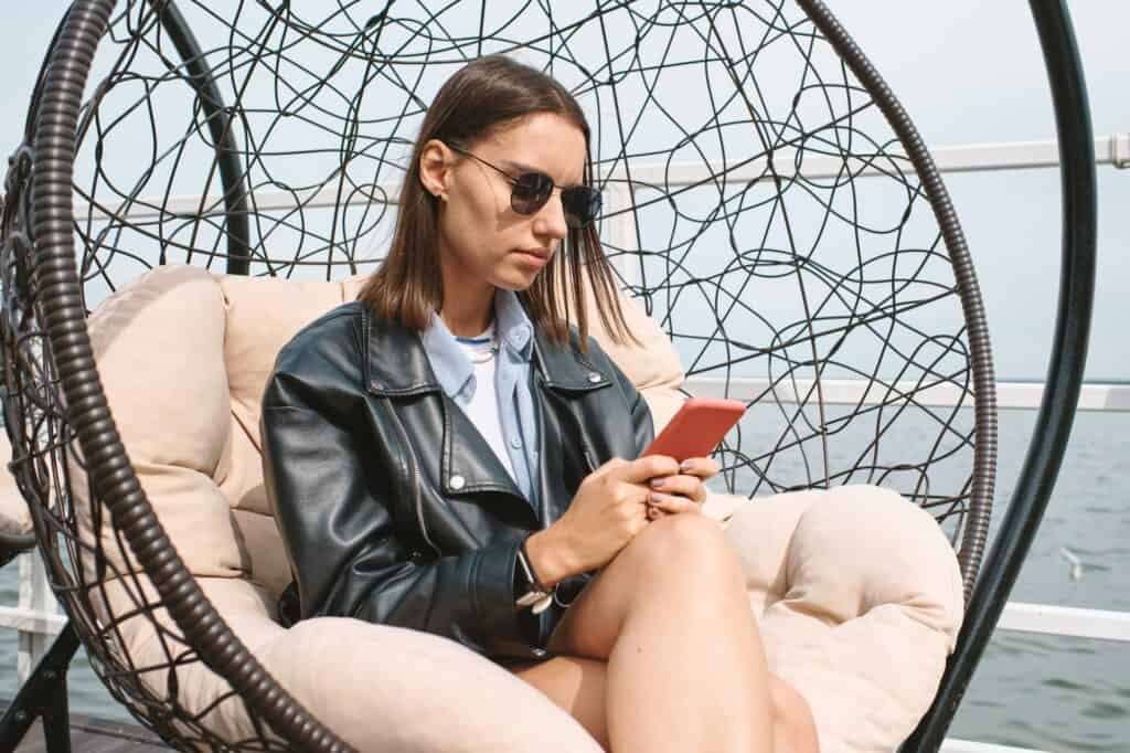 Woman in Sunglasses Sitting in Comfy Chair