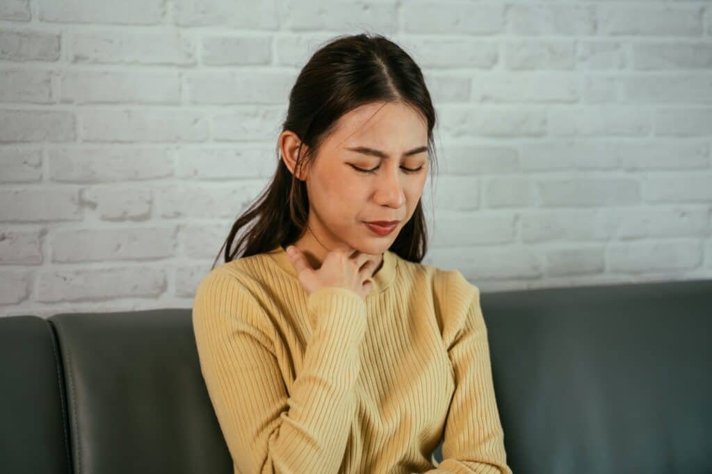 Woman suffering from sore throat
