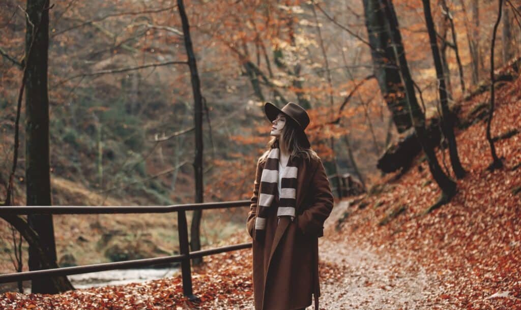 Young woman in hat in an autumn season park