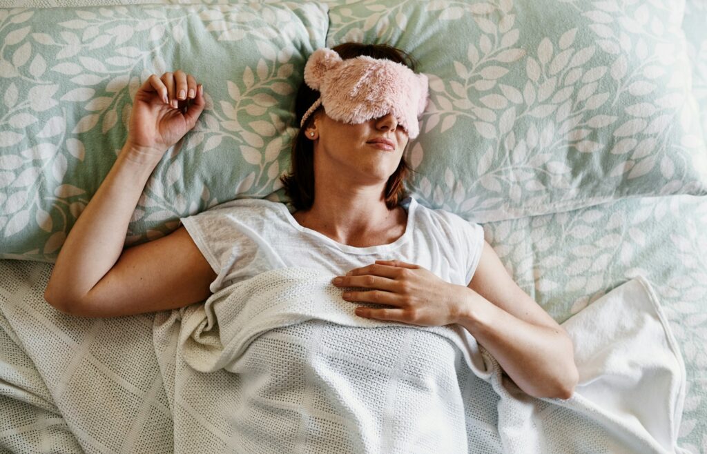 Shot of an attractive young woman sleeping with a sleep mask on in her bed at home