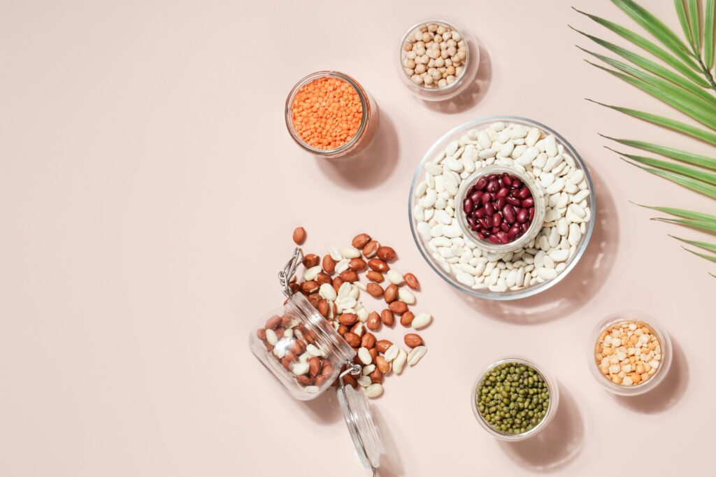 Vegan protein source. Beans, peas, chickpeas, lentils, mung bean, peanut in bowl on beige background