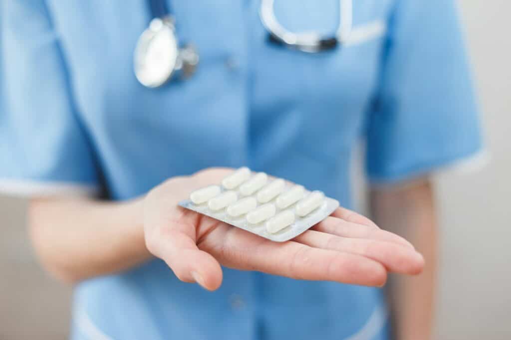 Doctor holds a blister with an antibiotic.