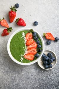 Colorful, healthy food. Acai green smoothie bowl. Keto breakfast idea.