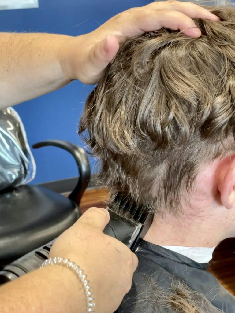 Teenage boy, thick naturally curly hair, getting summer haircut.